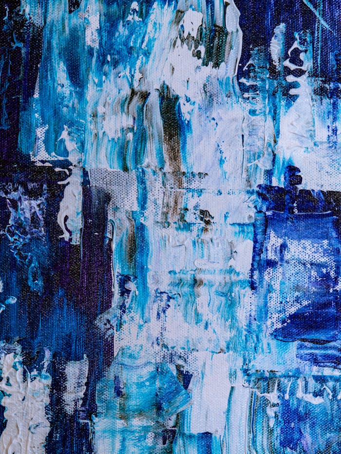 A vibrant abstract acrylic painting with blue, white, and brown hues, showcasing dynamic brush strokes.